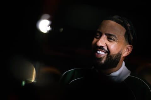 Moroccan-US rapper French Montana smiles during a visit to a gym in Paris, on June 25, 2025.