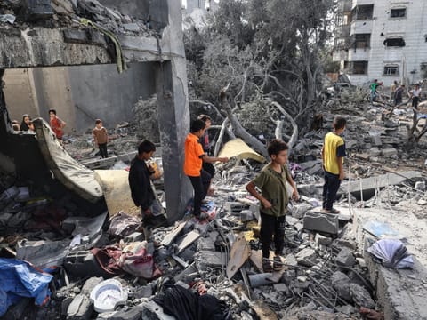 Palestinian children check the rubble of a residential house in Deir el-Balah in the central Gaza Strip on July 1, 2025, following overnight Israeli strikes as the war between the Palestinian Hamas militant and Israel continues.