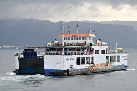A ferry boat sails as rescuers search for missing victims of a ferry accident in the waters off the Bali Strait near Jembrana on Bali Island on July 4, 2025.