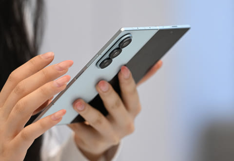 A visitor examines the Samsung Galaxy Z Fold7 smartphone at a Samsung store in Seoul on July 10, 2025.