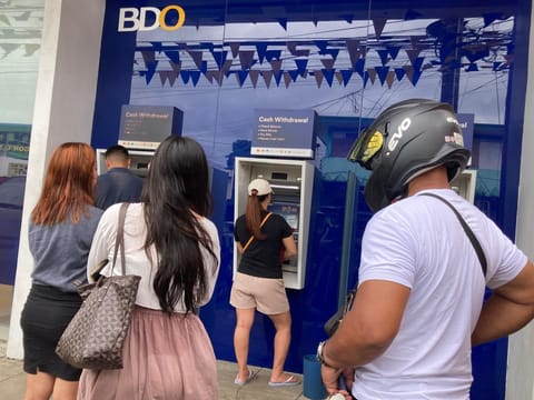 The peso's decline in the last three months (May to July 2025) reverses its relatively stable performance, earlier in the year. Photo shows customers forming a beeline to a local ATM machine.