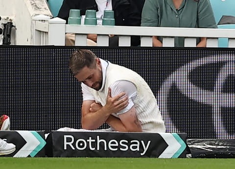 England's Chris Woakes holds his shoulder after falling over at the boundary on the first day of the fifth Test against India at The Oval in London on Thursday.