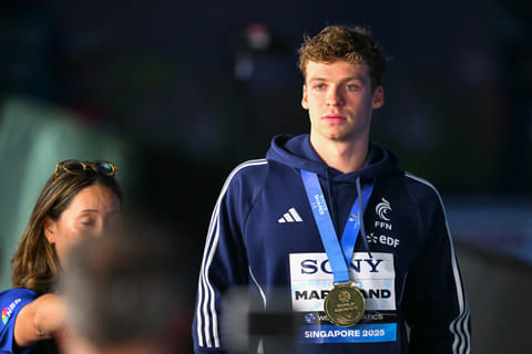 Gold medallist France's swimmer Leon Marchand celebrates on the podium of the men's 200m individual medley swimming event during the 2025 World Aquatics Championships in Singapore on July 31, 2025.