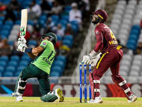 Hasan Nawaz (L) of Pakistan hits 6 as Shai Hope (R) of West Indies watches during the first ODI at Brian Lara Cricket Academy in Tarouba, San Fernando, Trinidad and Tobago on August 8, 2025.