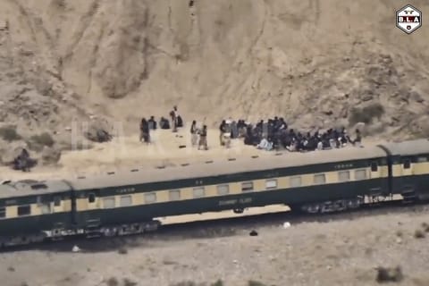FILE -In this frame grab from a video released by the Baluchistan Liberation Army shows people outside the a train after being attacked by the BLA on its transit from Quetta to the northern city of Peshawar, in Bolan district, Pakistan's southwestern Balochistan province, March 12, 2025..(BLA via AP, File)