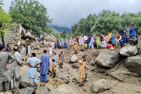 People gathered at the site of a flashflood in Salarzai Tehsil of Pakistan's Bajaur district on August 15, 2025.