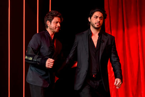 Bollywood actor Shah Rukh Khan (L) and his son Aryan Khan arrive to attend the preview of his son's directorial debut, Netflix's series 'The Ba***ds of Bollywood’, in Mumbai on August 20, 2025.