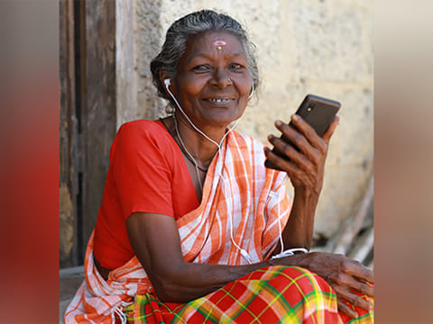 C Sarasu, 73, is using a smartphone. .