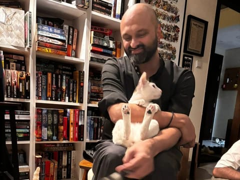 Aldrin Anthony Silva with his cats, Simba and Tino.