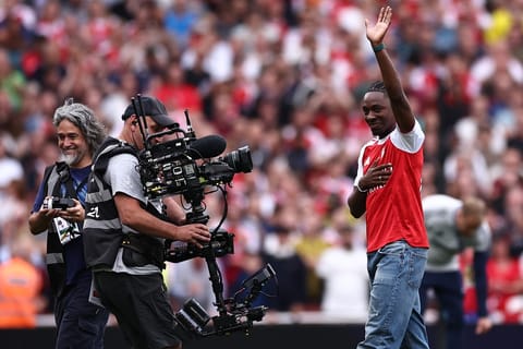 Eberechi Eze waves to the crowd as he is unveiled as a new signing ahead of the English Premier League football match between Arsenal and Leeds United at the Emirates Stadium in London on August 23, 2025.