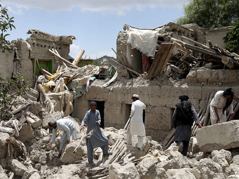 Residents at one of the buildings damaged by the earthquake.