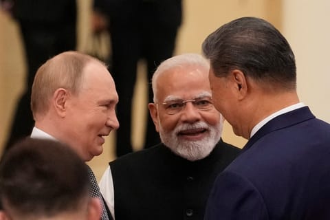 Indian Prime Minister Narendra Modi (C) talks with Russian President Vladimir Putin (L) and Chinese President Xi Jinping ahead of the Shanghai Cooperation Organisation (SCO) Summit 2025 at the Meijiang Convention and Exhibition Centre in Tianjin on September 1, 2025.