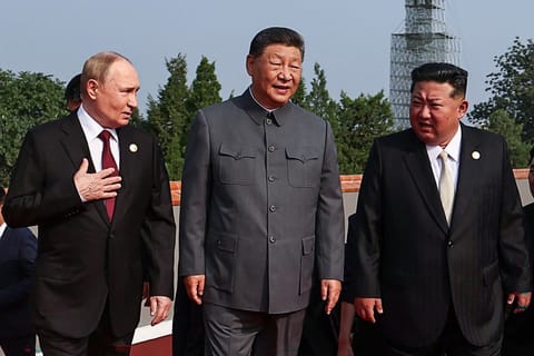 Russia's President Vladimir Putin walks with China's President Xi Jinping and North Korea's leader Kim Jong Un.
