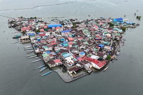This aerial view shows cramped houses on Isla Pugad in Hagonoy town, Bulacan province, north of Manila.