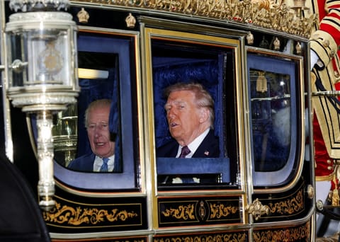 Britain's King Charles III and US President Donald Trump travel in The Irish State Coach during a horse-drawn procession towards Windsor Castle, in Windsor, on September 17, 2025, during a second State Visit.