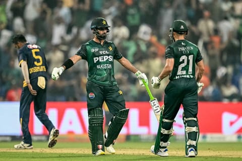 Pakistan's Hussain Talat chats with Mohammad Nawaz during the Asia Cup 2025 Super Four Twenty20 international cricket match against Sri Lanka at the Zayed Cricket Stadium in Abu Dhabi on September 23, 2025.