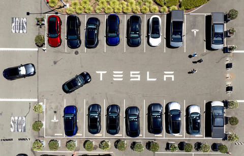 FILE - Tesla vehicles line a parking area at the company's Fremont, Calif., factory, Aug. 5, 2025. (AP Photo/Noah Berger)