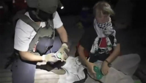 An Israeli soldier with Swedish climate activist Greta Thunberg (right) after several vessels of the Global Sumud Flotilla "have been safely stopped and their passengers being transferred to an Israeli port.". Israel