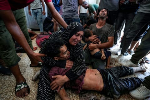 FILE.- Faten Mreish holds her son's body at a hospital morgue in Deir al-Balah, Gaza Strip, Aug. 28, 2024, after he and others were killed in an Israeli bombardment. (AP Photo/Abdel Kareem Hana,File)