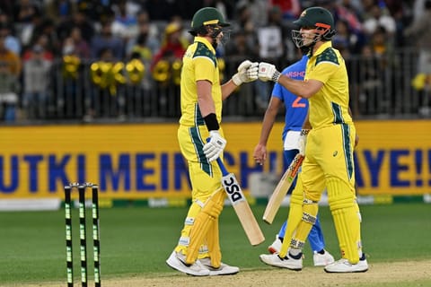 Australia's Matt Renshaw (L) and Mitchell Marsh exchange bump gloves during the first one-day international cricket match between Australia and India in Perth on October 19, 2025.