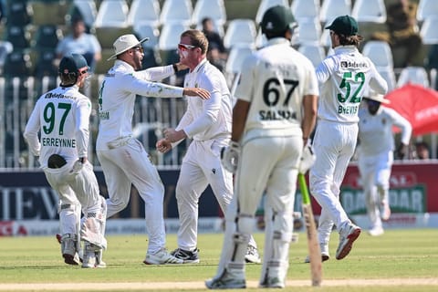 South Africa's Simon Harmer (C) celebrates with teammates after taking the wicket of Pakistan's Mohammad Rizwan during the fourth day of the second Test cricket match at the Rawalpindi Cricket Stadium in Rawalpindi on October 23, 2025.