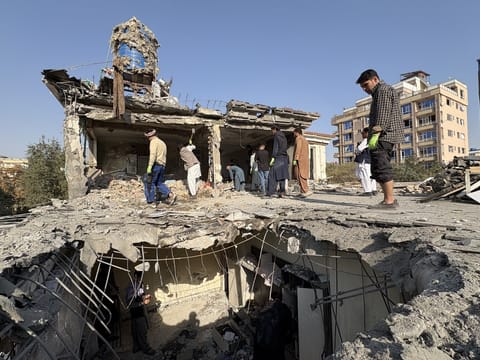 Residents remove debris from a house damaged by Wednesday's two drone strikes, in Kabul, Afghanistan, on October 16, 2025.