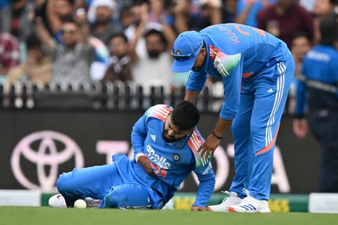 A file photo taken on October 25, 2025 shows India’s Shreyas Iyer (L) reacting in pain as he leaves the field during the third one-day international (ODI) men's cricket match between Australia and India at the Sydney Cricket Ground in Sydney.