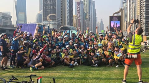 Cyclists at Dubai Ride 2025 pose on the sidelines