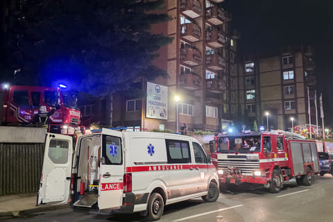 A rescue cars are parked in front of a nursing home after a fire in Tuzla, Bosnia, Tuesday, Nov. 4, 2025.