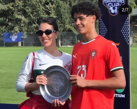 Cristiano Jr holding the trophy with his mother Georgina Rodriguez