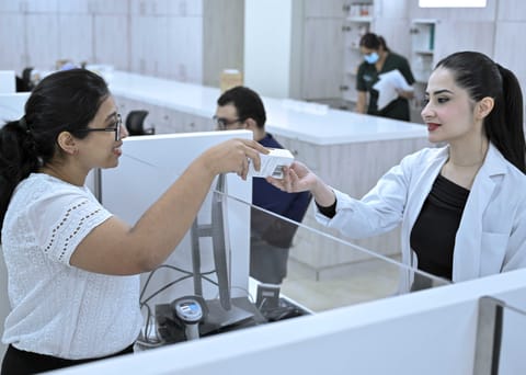 A patient buying an over-the-counter medicine from Burjeel Pharmacy.