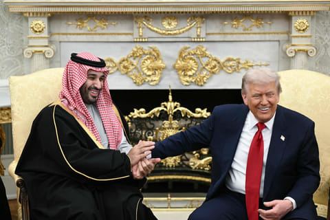 Trump jokes about hand shakes and fist pumps as he meets with Mohammed bin Salman in the Oval Office of the White House in Washington, DC on November 18, 2025.