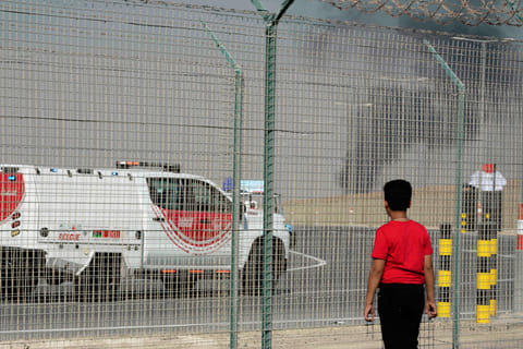 A bystander watches as an Indian HAL Tejas crashes during a demonstration at the Dubai Air Show, at Al Maktoum International Airport at Dubai World Central, Dubai, United Arab Emirates, Friday Nov. 21, 2025.