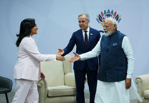 Canada's Prime Minister Mark Carney, middle, introduces Minister of Foreign Affairs Anita Anand, left, during a bilateral meeting with Indian Prime Minister Narendra Modi during the G20 Summit, in Johannesburg, Sunday, November 23, 2025.