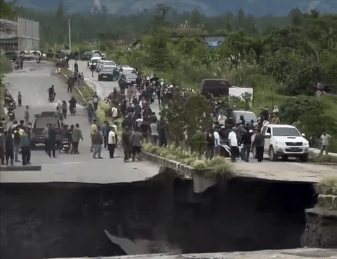 The video captured the incident showing the yawning gap on the road as chunks of asphalt and earth collapsed while people looked on during one of Southeast Asia's most devastating natural disasters.