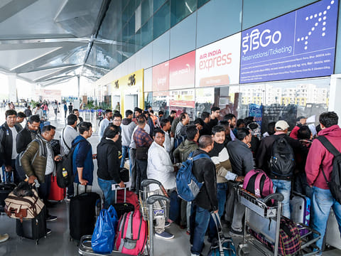 Passengers wait with their baggage as many IndiGo flight services stand cancelled at Jaiprakash Narayan International Airport, in Patna on Friday.