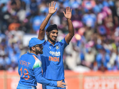 India's Arshdeep Singh (R) celebrates with teammate Virat Kohli after taking the wicket of South Africa's Ryan Rickelton during the third ODI at the Y.S. Rajasekhara Reddy Cricket Stadium in Visakhapatnam on December 6, 2025.