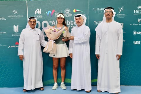 Al Habtoor Tennis Challenge champion Petra Marcinko receives the trophy from Khalaf Al Habtoor, Ahmed Abdul Malik and Nasser Al Marzooki of the UAE Tennis Federation.