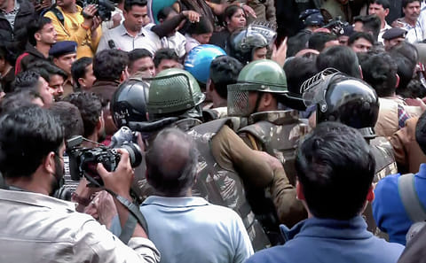 Security forces reach the spot as BJP workers, along with locals, hold a protest against the Congress delegation at the Bhagirathpura area on the water contamination issue, in Indore on Saturday.