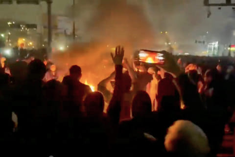 In this frame grab from footage circulating on social media shows protesters dancing and cheering around a bonfire as they take to the streets despite an intensifying crackdown as the Islamic Republic remains cut off from the rest of the world, in Tehran, Ion January 9, 2026.