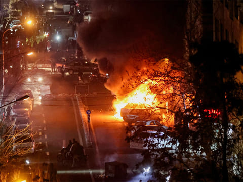 Cars burn during protests over the collapse of the currency’s value in Tehran, Iran. (Photo/Reuters)