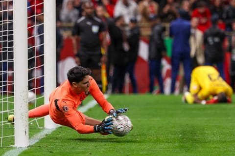 Morocco's goalkeeper #01 Yassine Bounou stops a penaly kick from Nigeria's forward #11 Samuel Chukwueze during the Africa Cup of Nations (CAN) semi-final football match between Nigeria and Morocco at the Prince Moulay Abdellah stadium in Rabat on January 14, 2026.