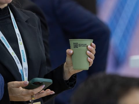 WFES attendee with an ‘Again, Please’ reusable cup at the ADNEC Centre Abu Dhabi this week.