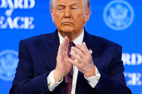 President Donald Trump applauses during a signing ceremony on his Board of Peace initiative at the Annual Meeting of the World Economic Forum in Davos, Switzerland, Thursday, Jan. 22, 2026. (AP Photo/Markus Schreiber)