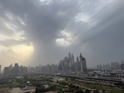 Rain clouds hover above the Dubai skyline