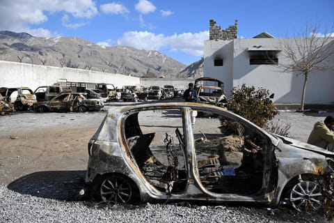 Burnt vehicles inside a torched police station on the outskirts of Quetta on February 1, 2026 a day after an attack by Baloch militants.