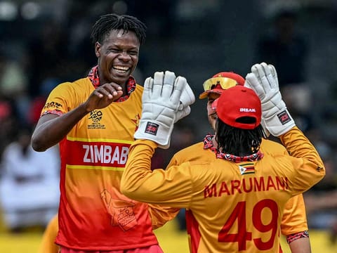 Zimbabwe's Blessing Muzarabani (L) celebrates with teammates after taking the wicket of Australia's Adam Zampa during the 2026 ICC Men's T20 Cricket World Cup group stage match at the R Premadasa Stadium in Colombo on February 13, 2026.