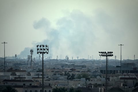 Smoke rises from an area in the direction of Al Udeid Air Base, which houses the Qatar Emiri Air Force and foreign forces including the US, in Doha on February 28, 2026, following a reported Iranian strike.