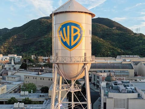 In an aerial view, the Warner Bros. logo is displayed on the water tower at Warner Bros. Studio on February 27, 2026 in Burbank, California.
