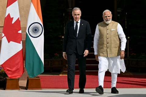 India's Prime Minister Narendra Modi (R) walks with his Canadian counterpart Mark Carney before their meeting at the Hyderabad House in New Delhi on March 2, 2026.